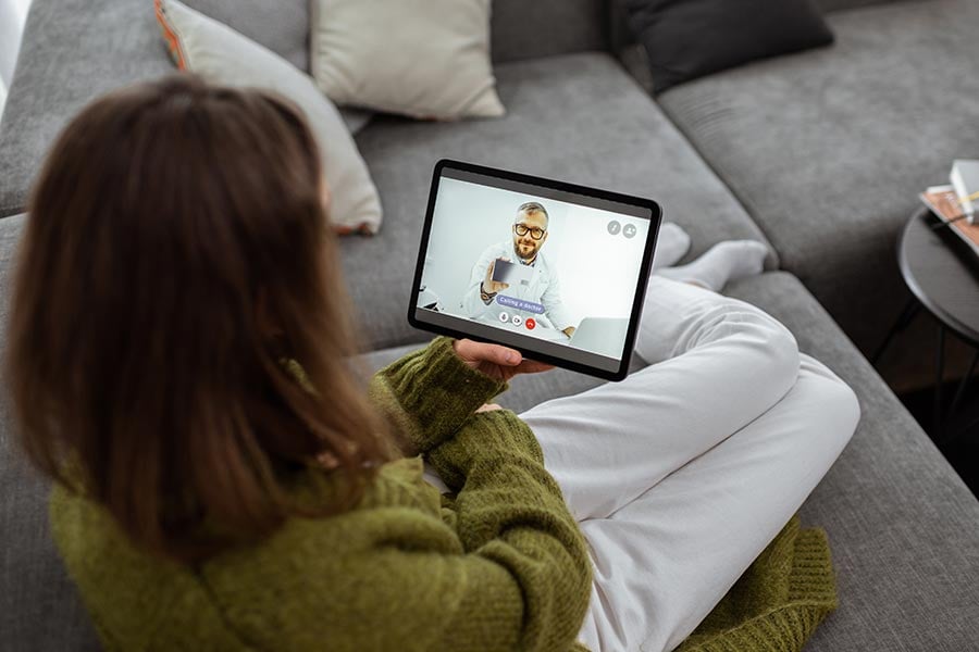 Woman on tablet with counselor